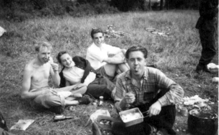 Camping at Bovingdon. Tom and Sheila are on the left; Bob Harvey (right) eats a sausage.